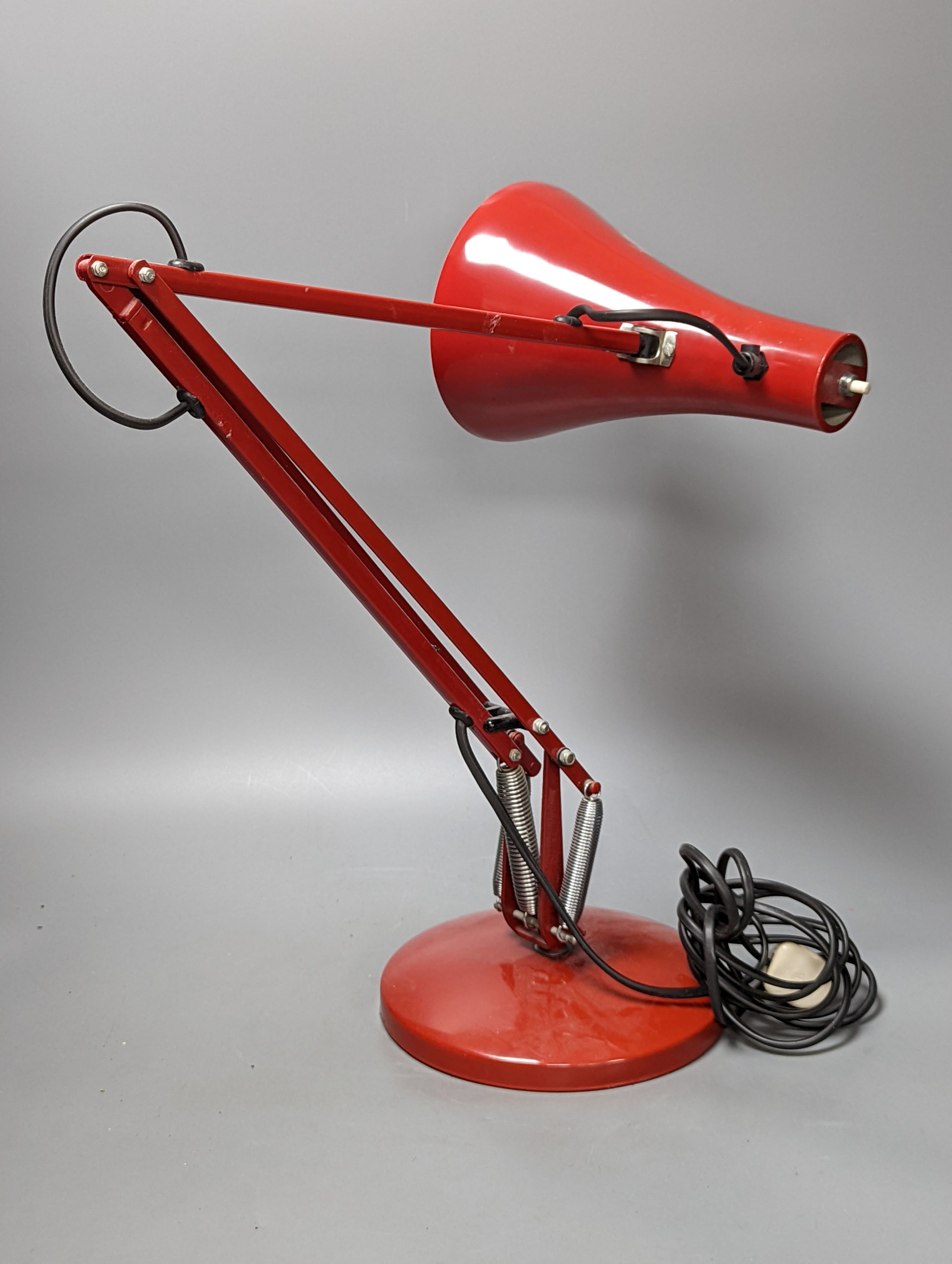 A red anglepoise table lamp, 79 cms high.